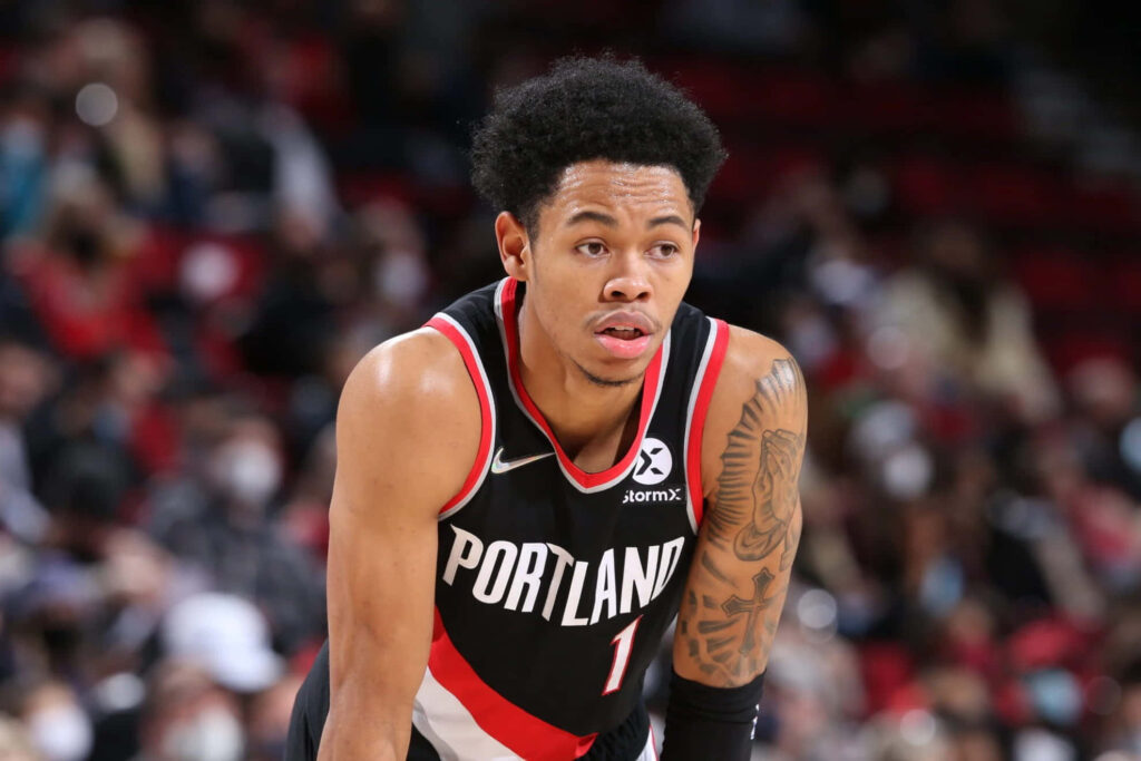 Anfernee Simons in Portland Trail Blazers uniform focused on basketball court action wallpaper