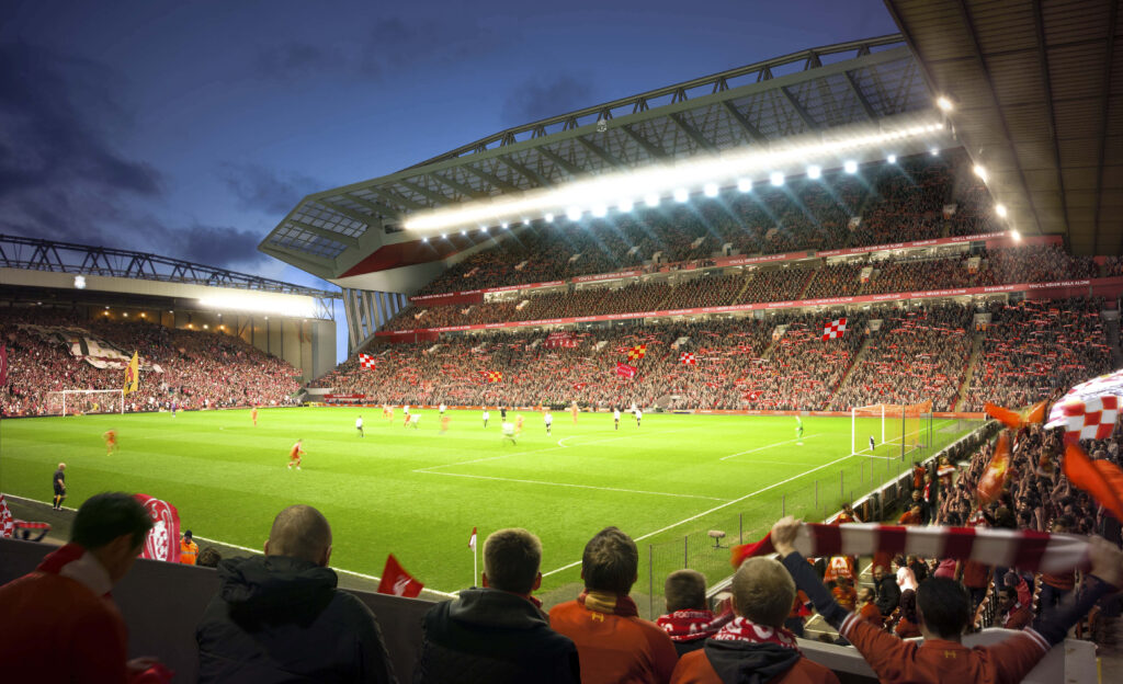 Anfield Stadium glowing at night with cheering Liverpool fans during an exciting football match Wallpaper