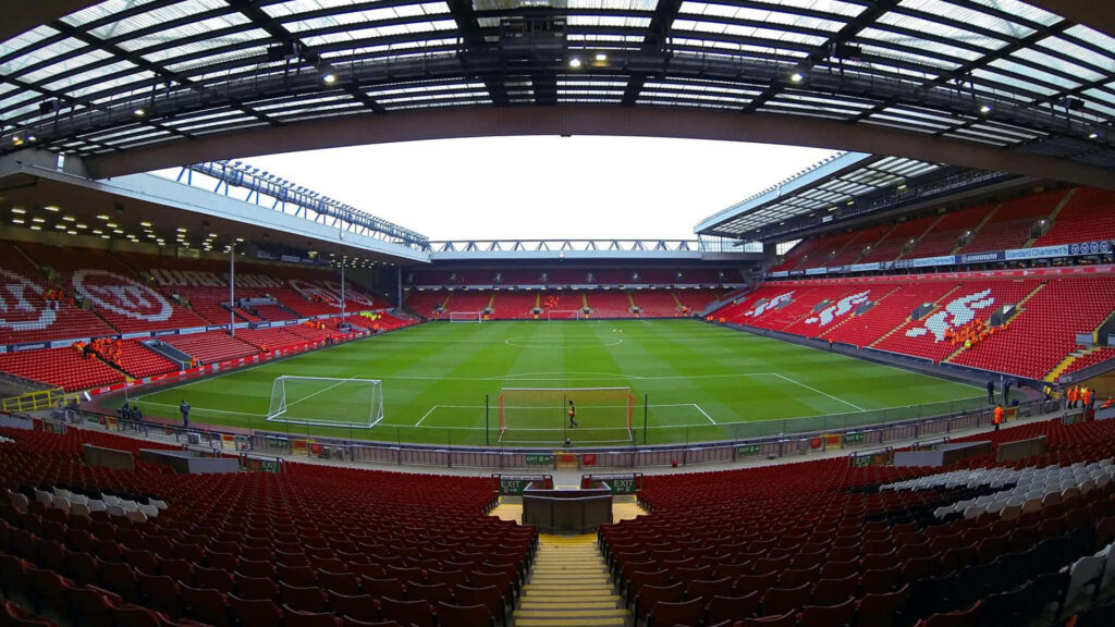 Anfield Stadium interior view vibrant red stands pristine pitch central perspective wallpaper