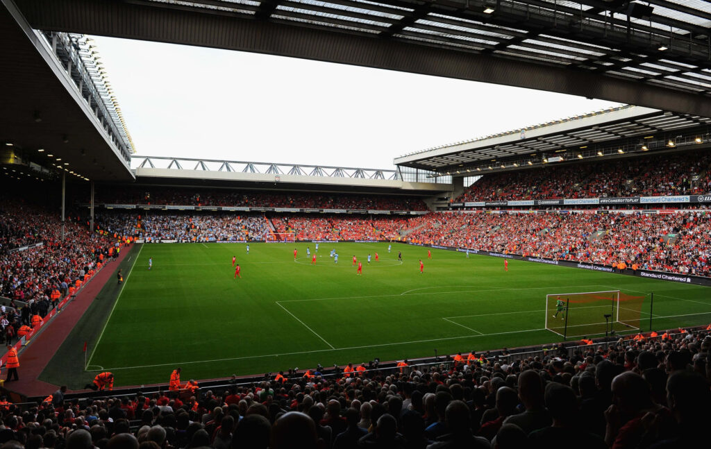Lively Anfield Stadium match day with passionate Liverpool fans cheering on football teams playing Wallpaper