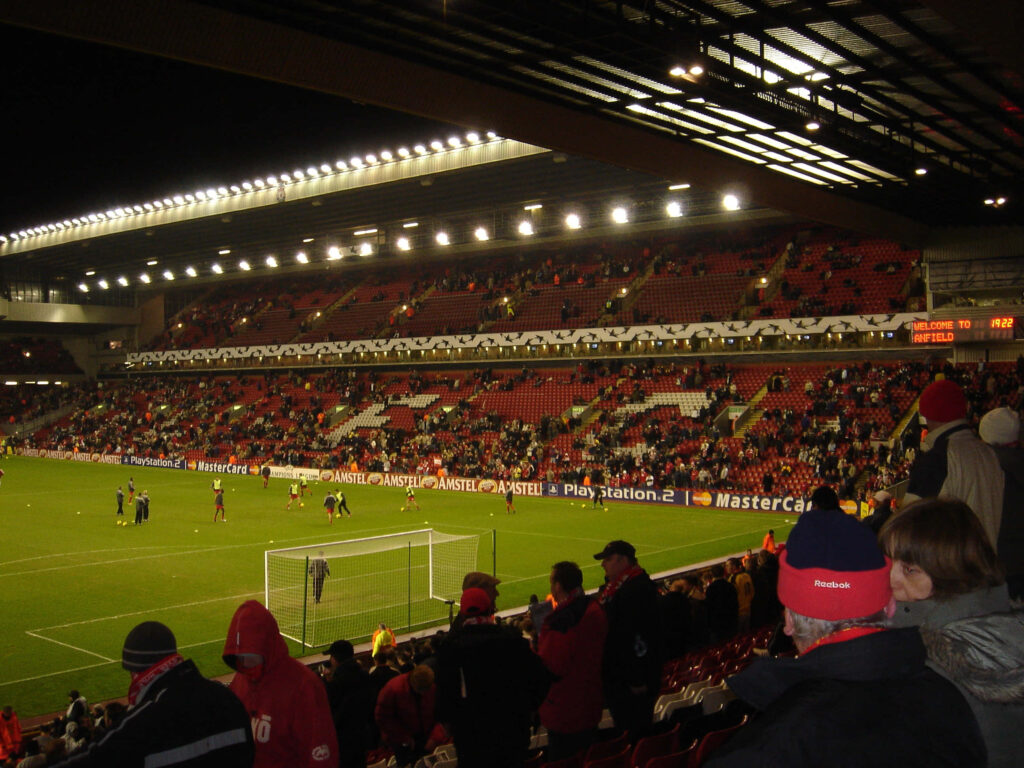 Anfield Stadium night match wallpaper vibrant stands full of passionate football fans energy background