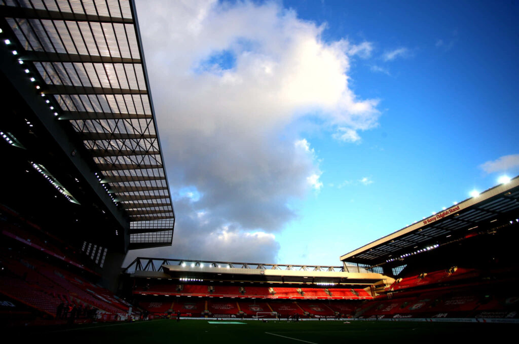 Anfield Stadium sunset silhouette with grandstands and soft evening light football ground wallpaper