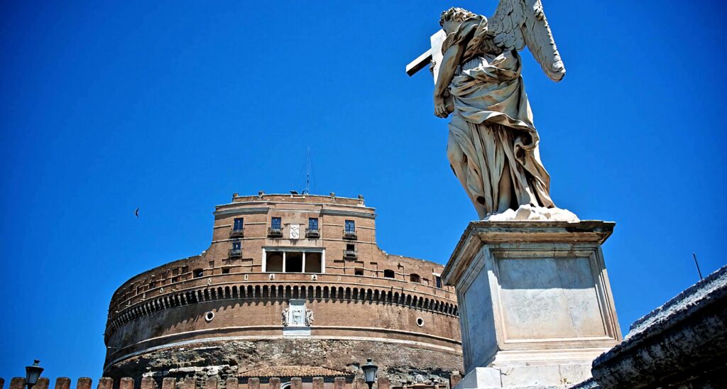 Angel Carrying The Cross statue at Castel Sant'Angelo Rome under vivid blue sky wallpaper