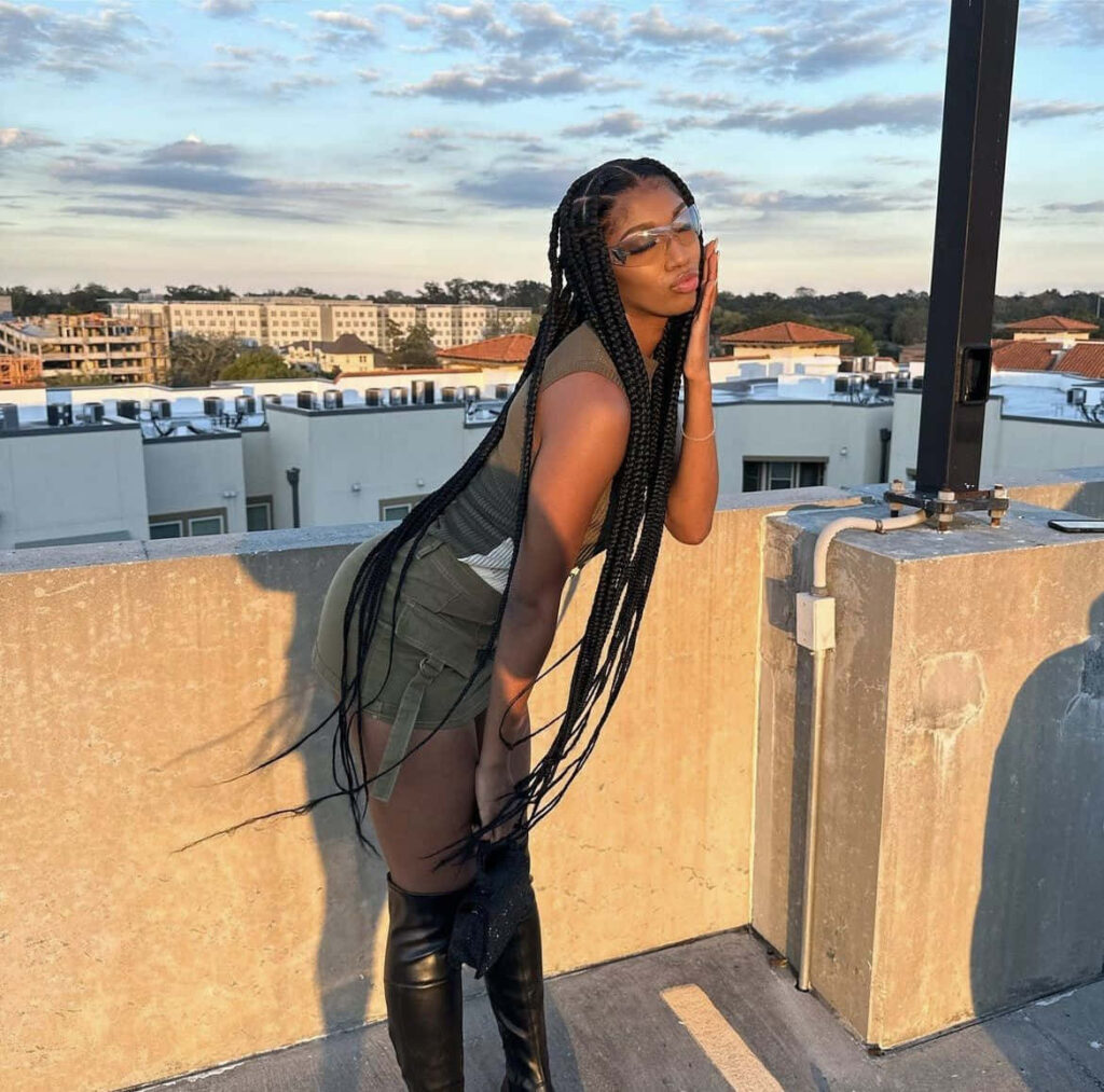 Angel Reese stylish rooftop sunset pose urban sophistication glamour scenic city skyline background Wallpaper