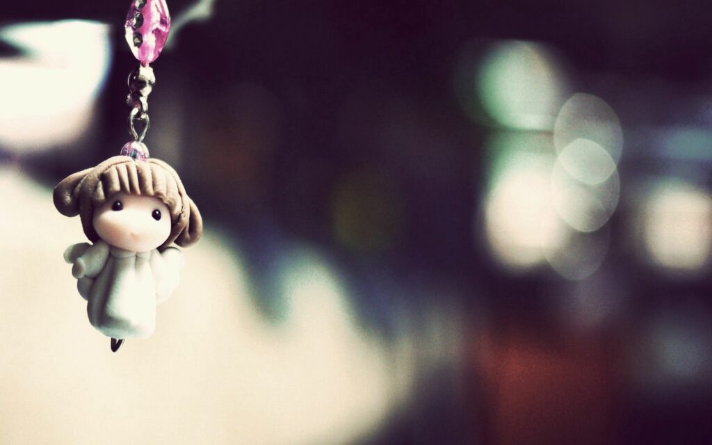 Cute Angelic Keychain on Dreamy Wallpaper Background