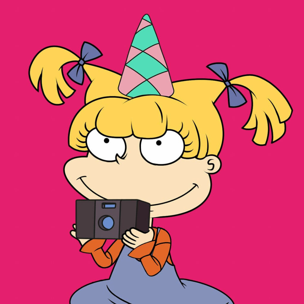 Angelica Pickles celebrating with colorful party hat holding camera bright pink background wallpaper
