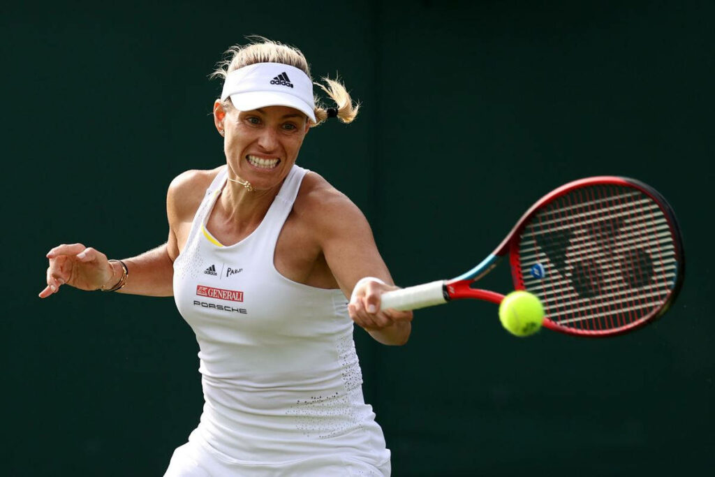 Angelique Kerber hitting tennis ball with intense focus power in competitive match wallpaper background