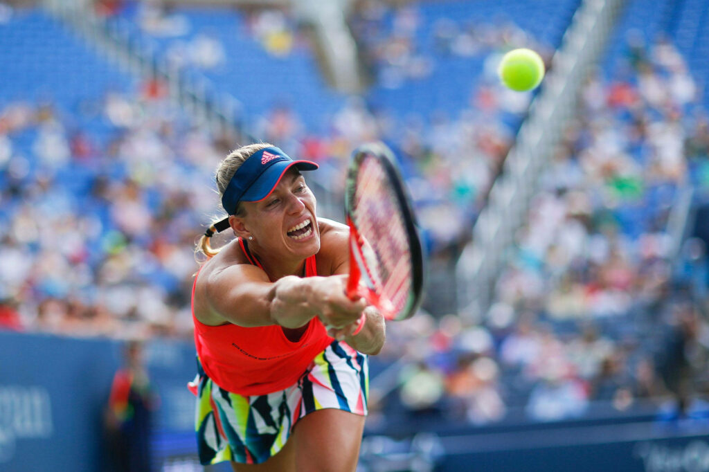 Angelique Kerber mid-air stretch reaching fast tennis ball showing focus and athleticism wallpaper