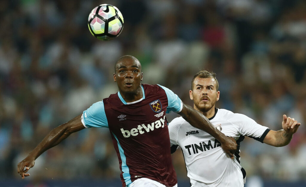 Angelo Ogbonna jumps high in intense football aerial duel during dynamic match action wallpaper