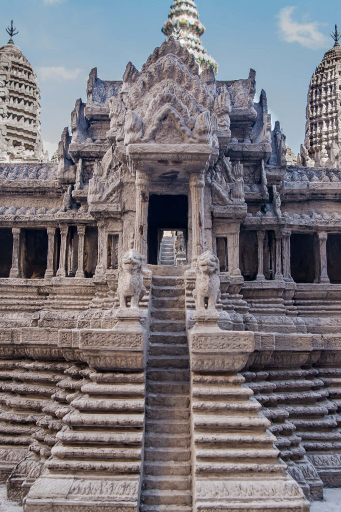 Ancient Angkor Thom Temple stone staircase and guardian statues under clear blue sky wallpaper