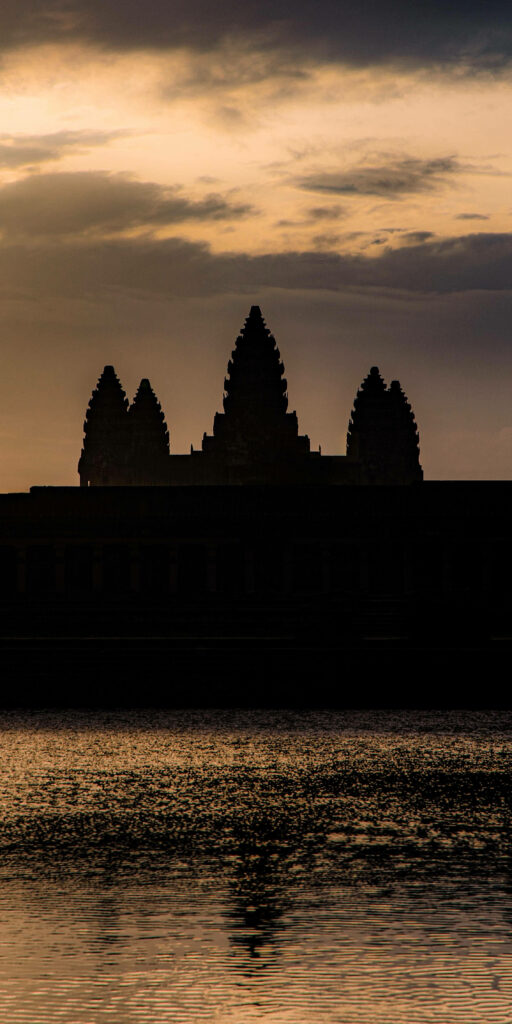 Brown Angkor Wat phone wallpaper with temple silhouette sunset and water reflection peaceful scene
