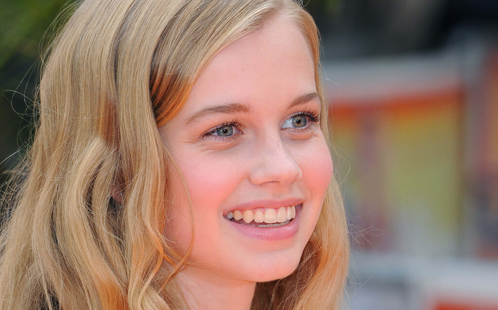 Closeup of Angourie Rice smiling with blonde hair showcasing natural beauty wallpaper background