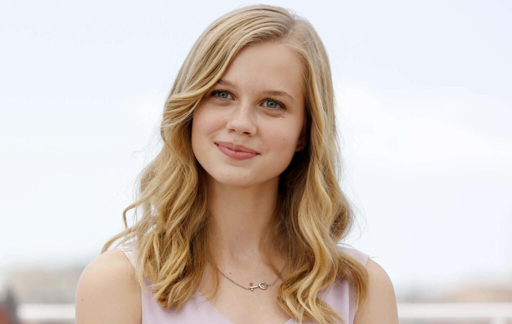 Angourie Rice smiling softly outdoors bright elegant wallpaper background natural light