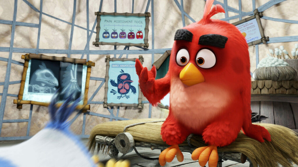 Angry Birds Red character in office with framed charts creating a creative workspace wallpaper