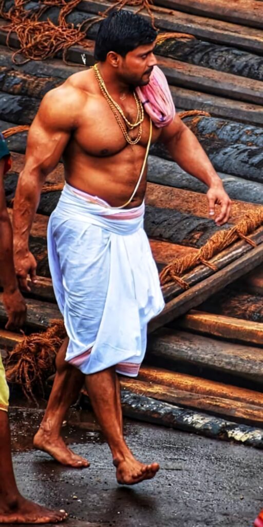 Anil Gochikar muscular bodybuilder walking barefoot in traditional attire HD wallpaper background