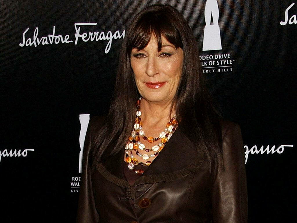 Anjelica Huston in dark blazer and statement necklace posing at Rodeo Drive event backdrop wallpaper