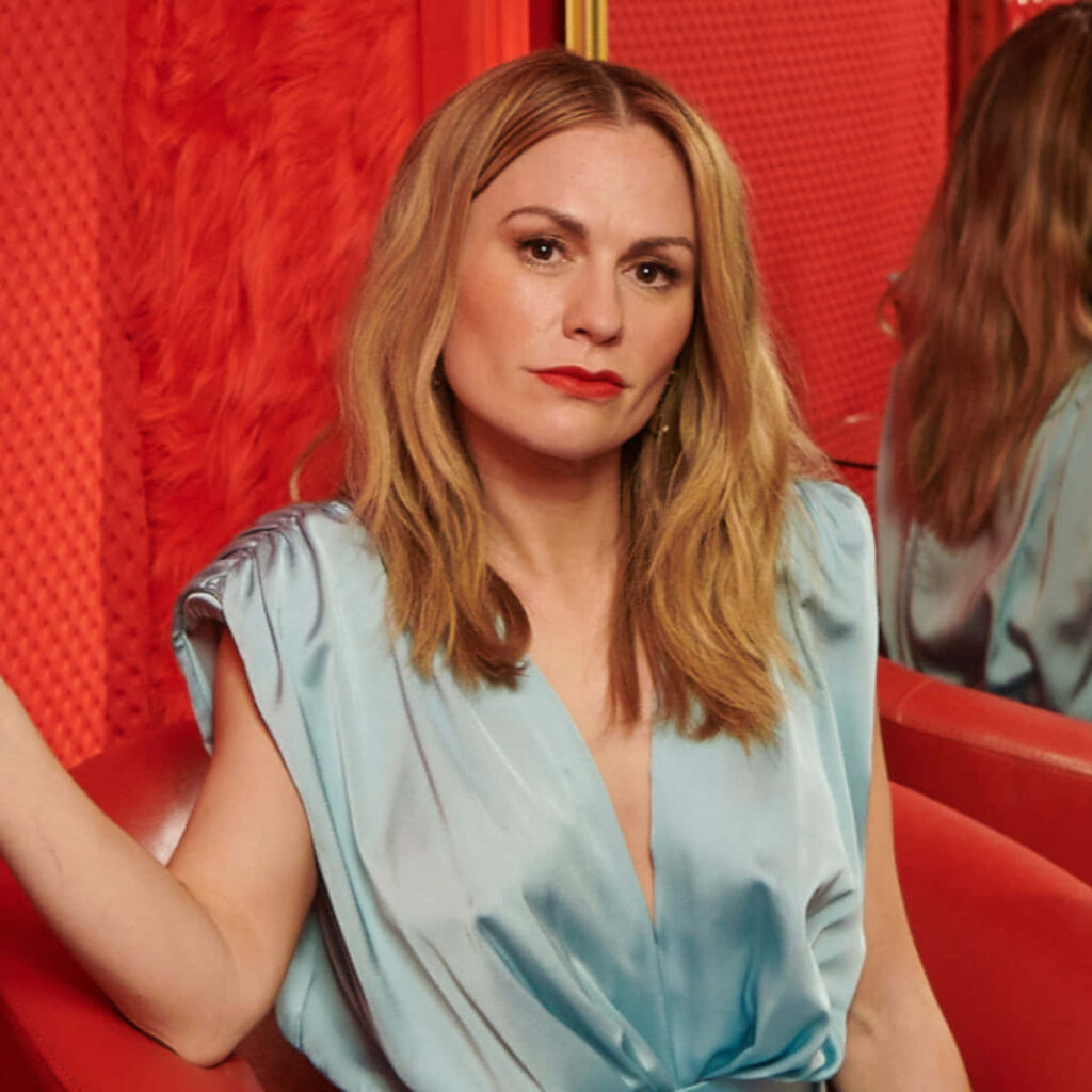 Anna Paquin confident pose bold stylish wallpaper with vivid red backdrop for background design