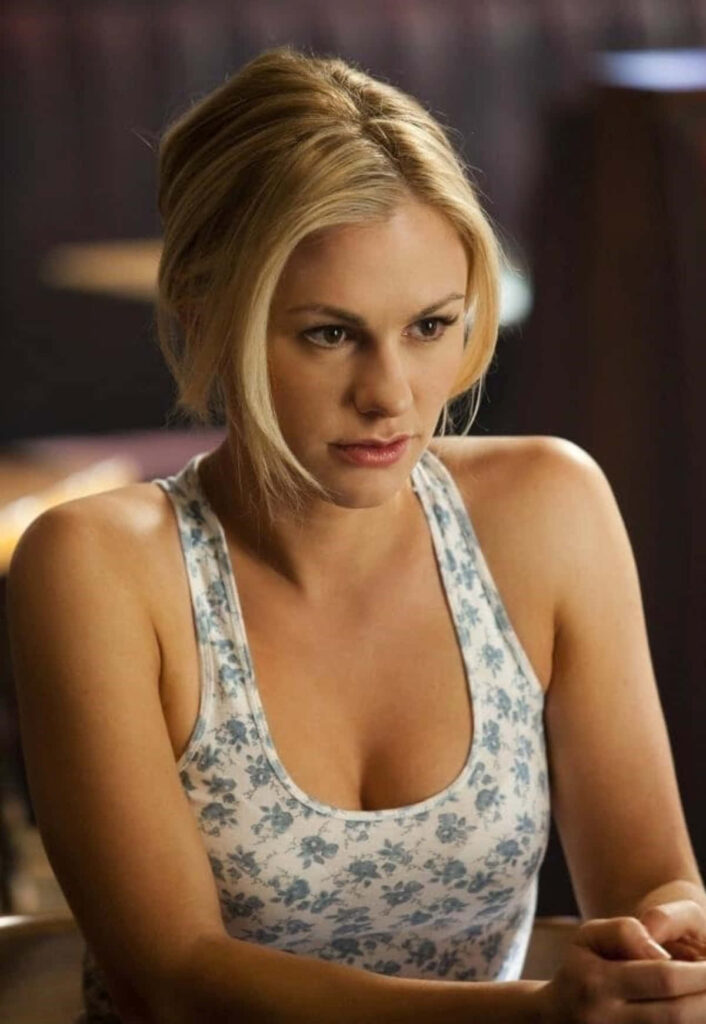 Anna Paquin indoor portrait wearing floral tank top with concerned expression wallpaper background