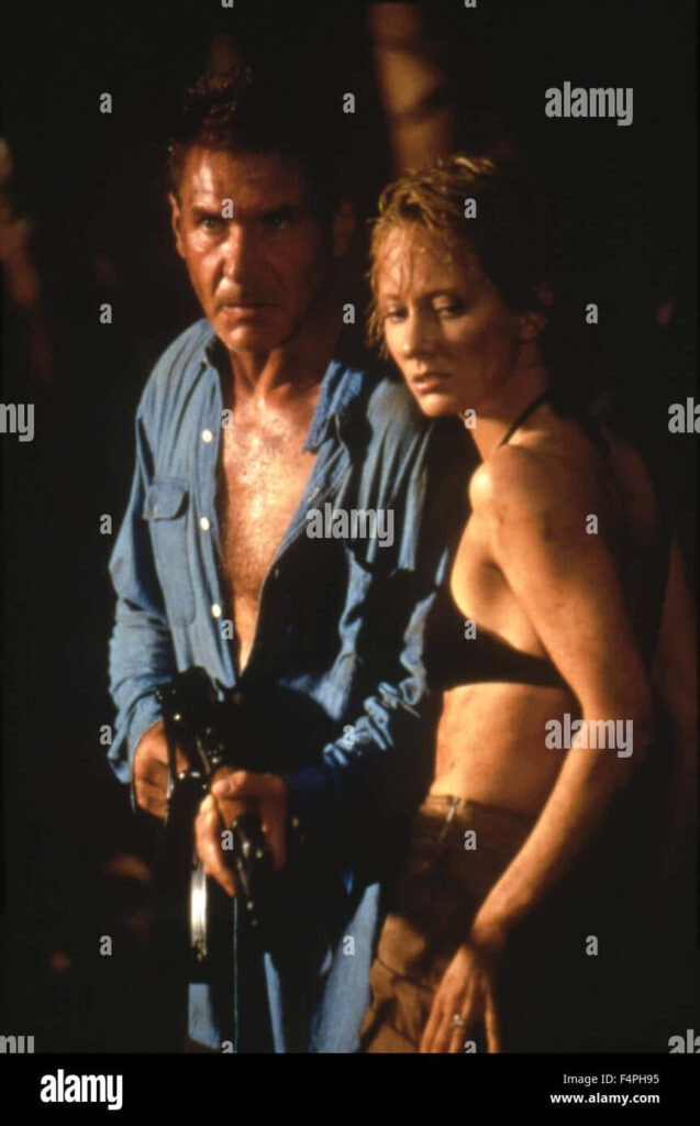 Anne Heche with male companion in intense adventure scene showing determined expression wallpaper