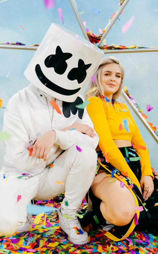 Anne-Marie and Marshmello playful pose with colorful confetti vibrant music wallpaper background
