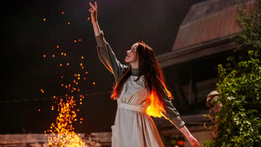 Anne reaching toward glowing sparks by fire rustic Anne With An E wallpaper background scene