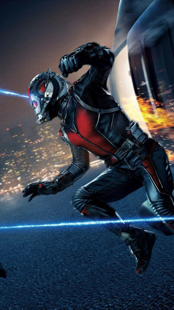 Ant Man superhero leaping in iconic suit with dynamic cityscape action wallpaper background