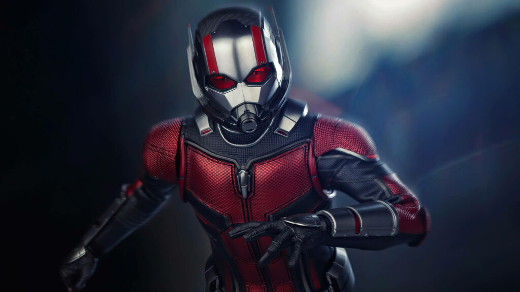 Ant Man in red and black suit in tiny superhero form on dramatic blurred wallpaper background