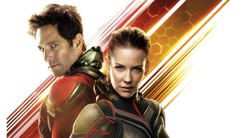 Ant Man and The Wasp in superhero suits back to back on gold red honeycomb pattern wallpaper