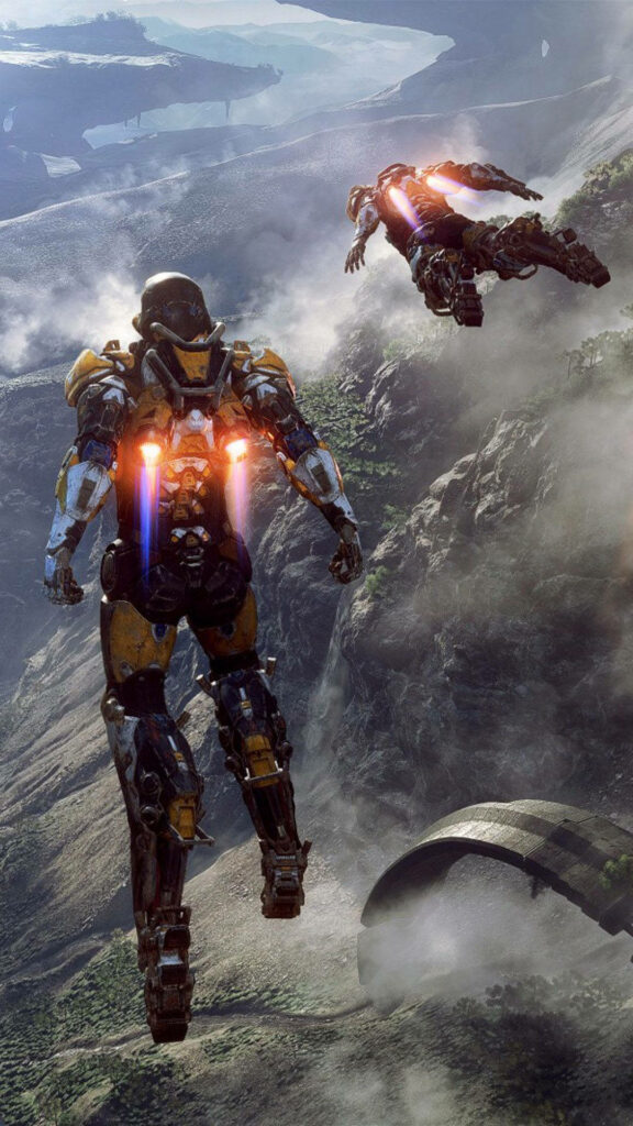 Two armored exosuit pilots fly over mountains in Anthem game sci fi action wallpaper background