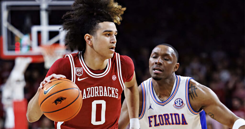 Anthony Black dribbling past Florida defender intense Arkansas Razorbacks basketball game wallpaper