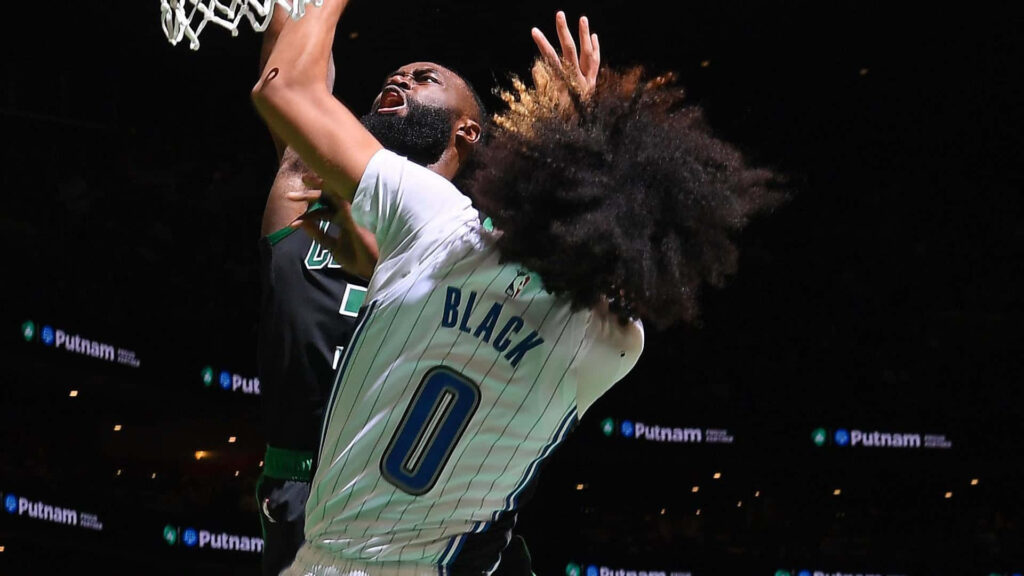 Anthony Black jumps high for a powerful dunk in an intense basketball action scene wallpaper