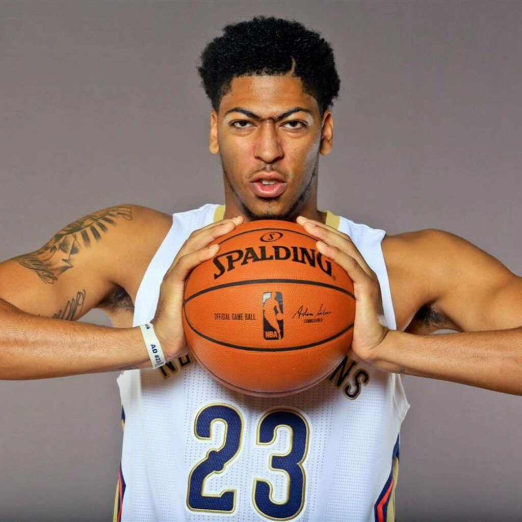 Anthony Davis in New Orleans Pelicans jersey holding basketball intense focused NBA wallpaper