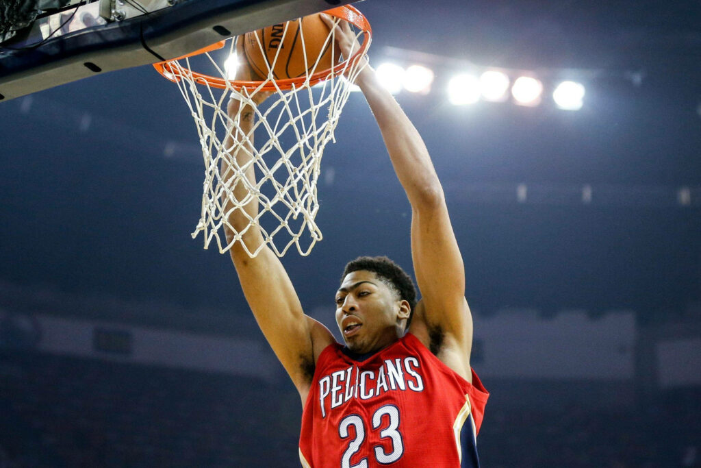 Anthony Davis dunking in New Orleans Pelicans jersey electrifying basketball action wallpaper