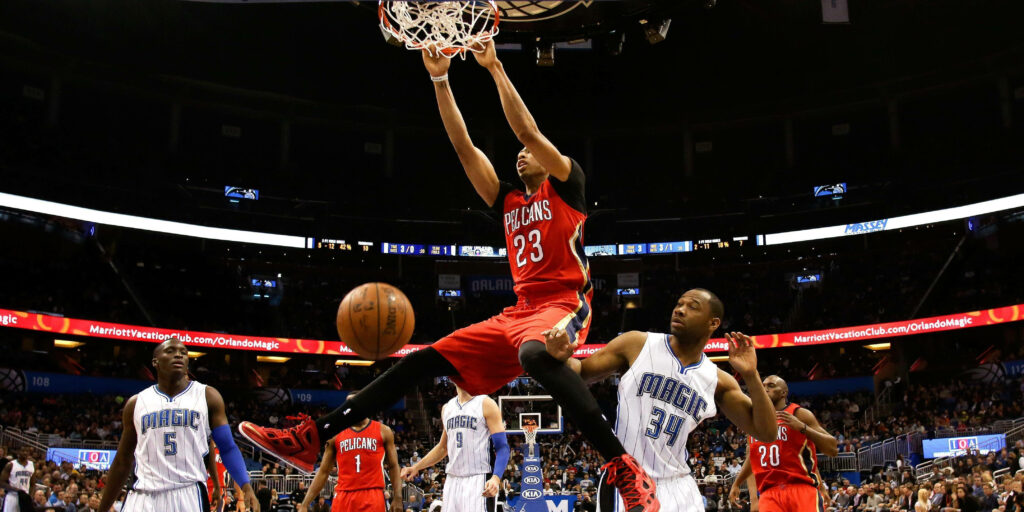 Anthony Davis soaring for a powerful slam dunk showcasing basketball athleticism and dominance Wallpaper