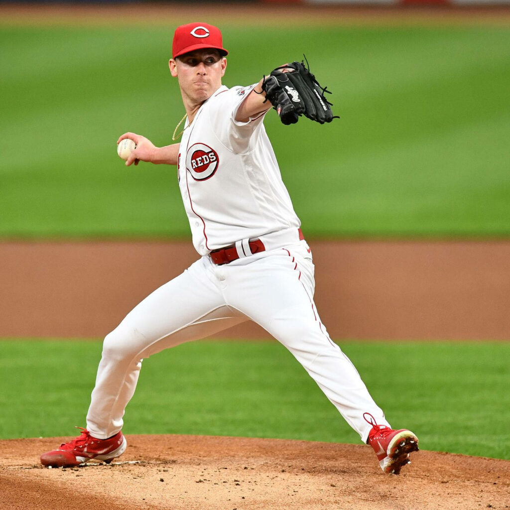 Pitcher Anthony DeSclafani in Cincinnati Reds uniform winding up to pitch on mound wallpaper