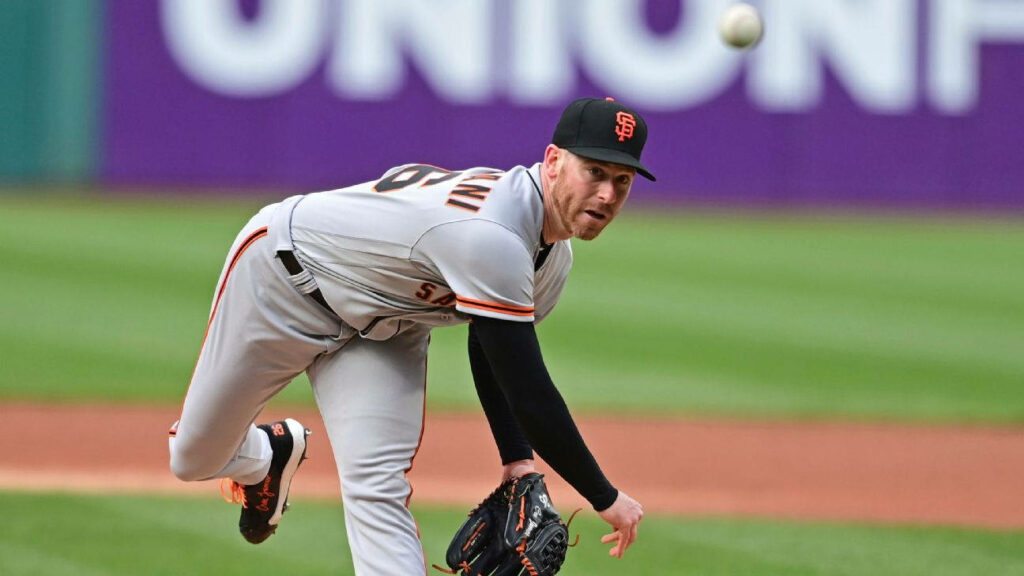 Anthony DeSclafani pitching in San Francisco Giants uniform with vibrant stadium backdrop Wallpaper