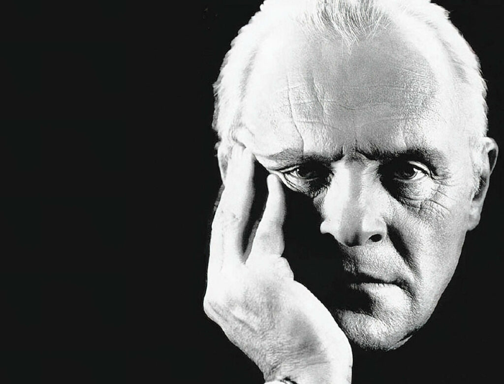 Black and white wallpaper of Anthony Hopkins with dramatic lighting and thoughtful expression