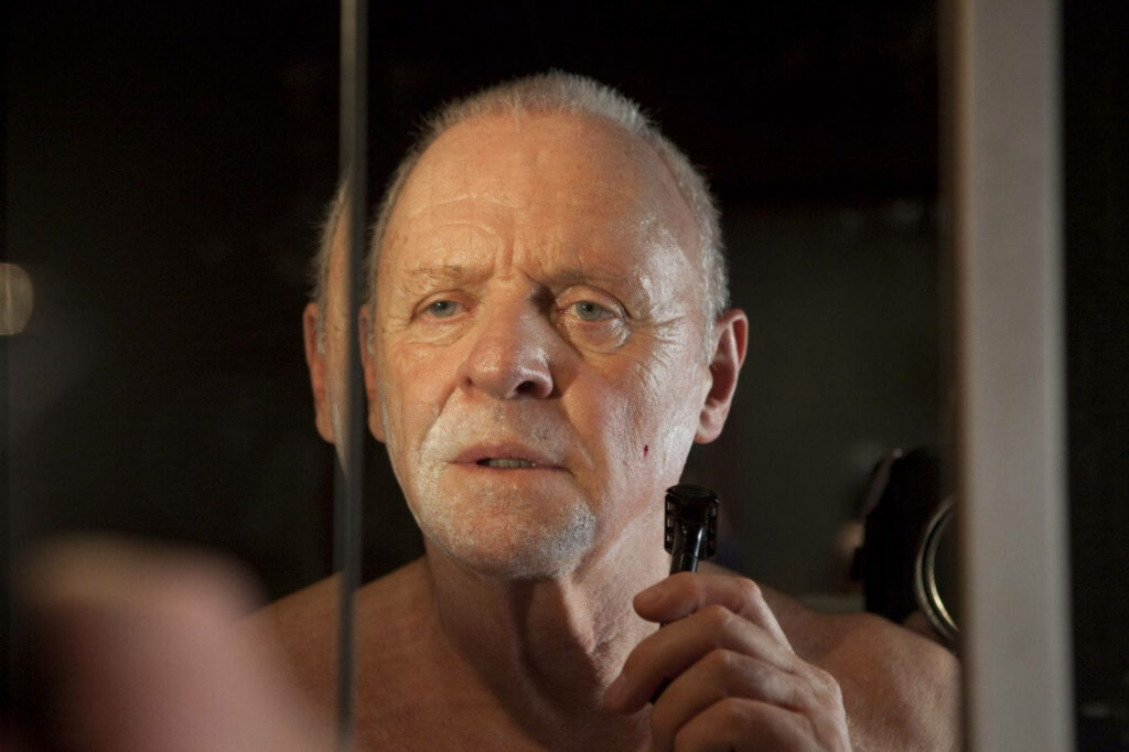 Anthony Hopkins shaving thoughtfully in mirror candid wallpaper background close up portrait