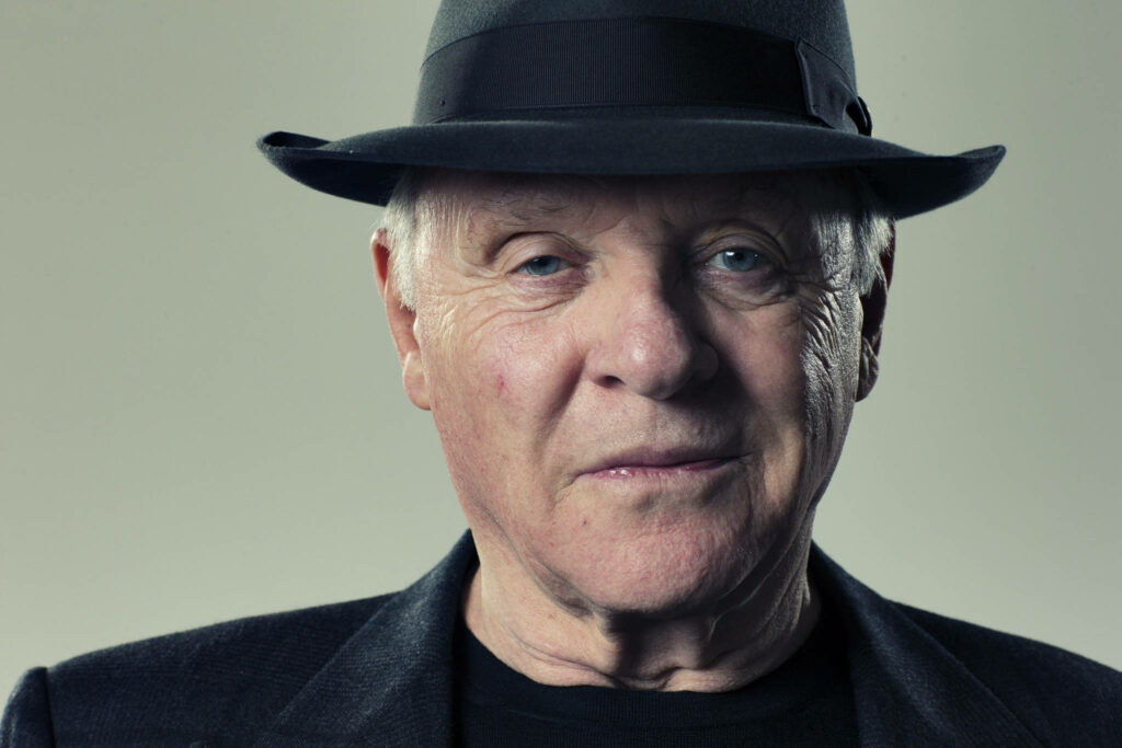 Anthony Hopkins portrait wearing classic black fedora and dark jacket timeless elegant style Wallpaper