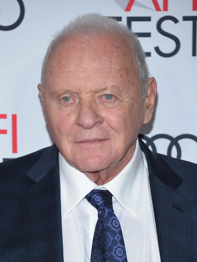 Anthony Hopkins on stage in checked suit and patterned tie classic style professional backdrop Wallpaper