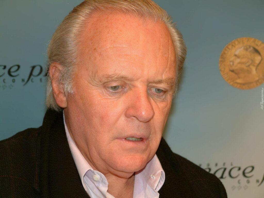 Close-up of Anthony Hopkins with expressive forehead and thoughtful expression on blurred background Wallpaper