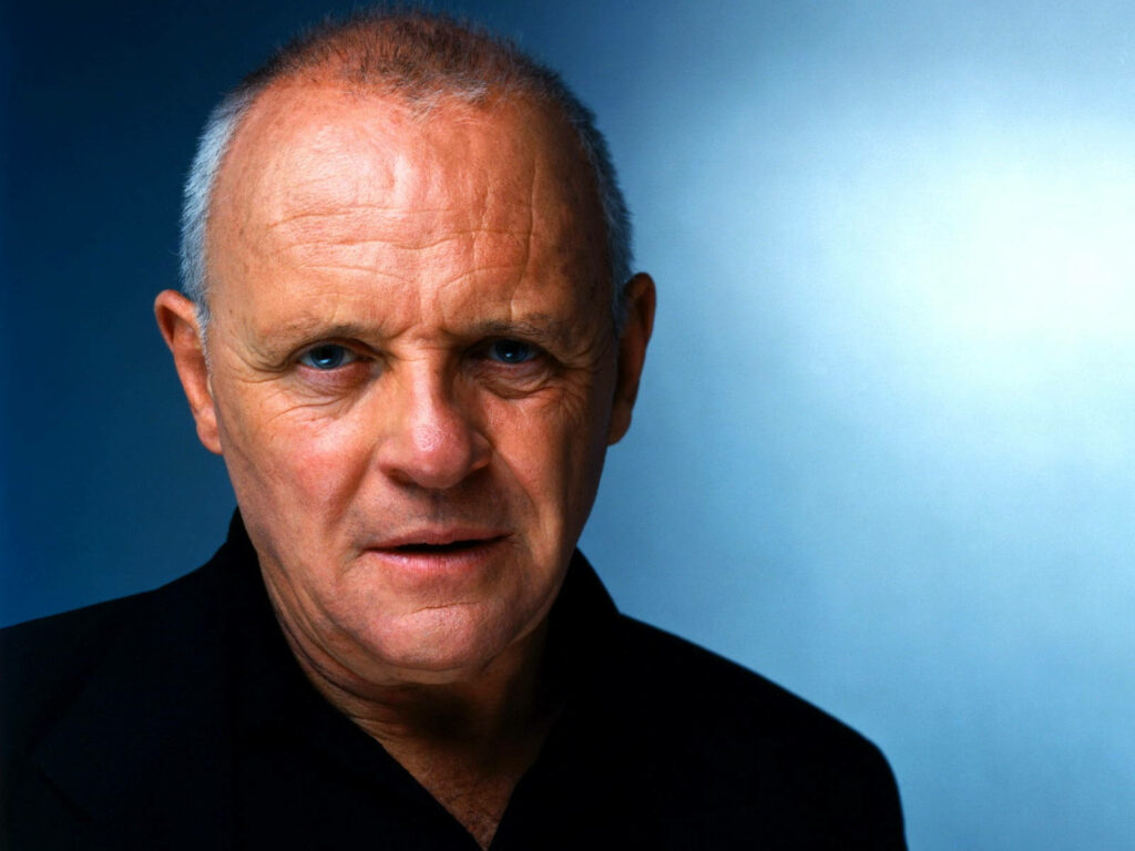 Anthony Hopkins portrait studio intense gaze distinguished presence soft blue background wallpaper