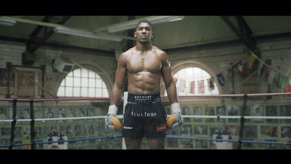 Anthony Joshua confident in boxing ring showing muscular abs athletic physique powerful wallpaper