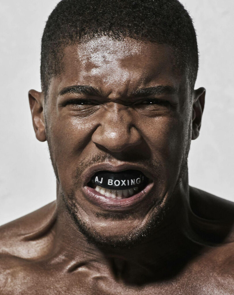 Anthony Joshua fierce expression wearing AJ Boxing mouthguard showing strength in boxing wallpaper