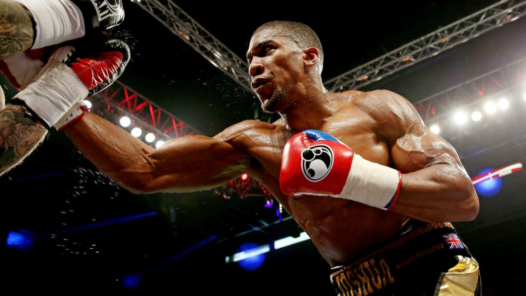 Anthony Joshua boxing punch strength determination in ring under bright arena lights wallpaper