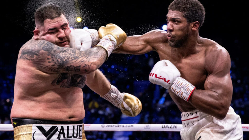 Anthony Joshua delivers a strong punch to Andy Ruiz Jr in intense heavyweight boxing match action Wallpaper