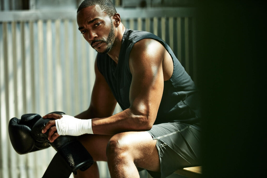 Anthony Mackie in athletic gear holding boxing gloves showing strength and focus wallpaper
