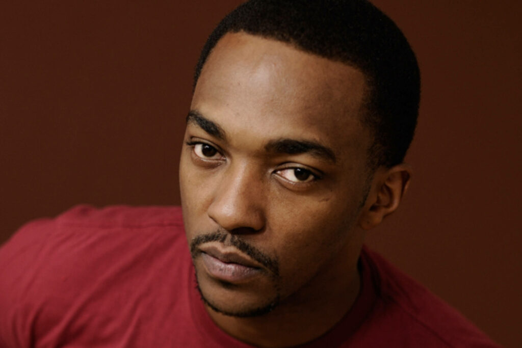 Anthony Mackie close-up portrait intense gaze warm background serious focused expression wallpaper