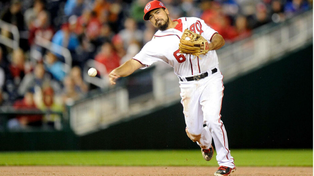 Anthony Rendon making a focused baseball play extending his arm in intense professional game action Wallpaper