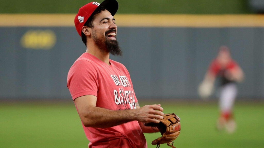 Anthony Rendon laughing on baseball field in red outfit holding glove lively cheerful wallpaper